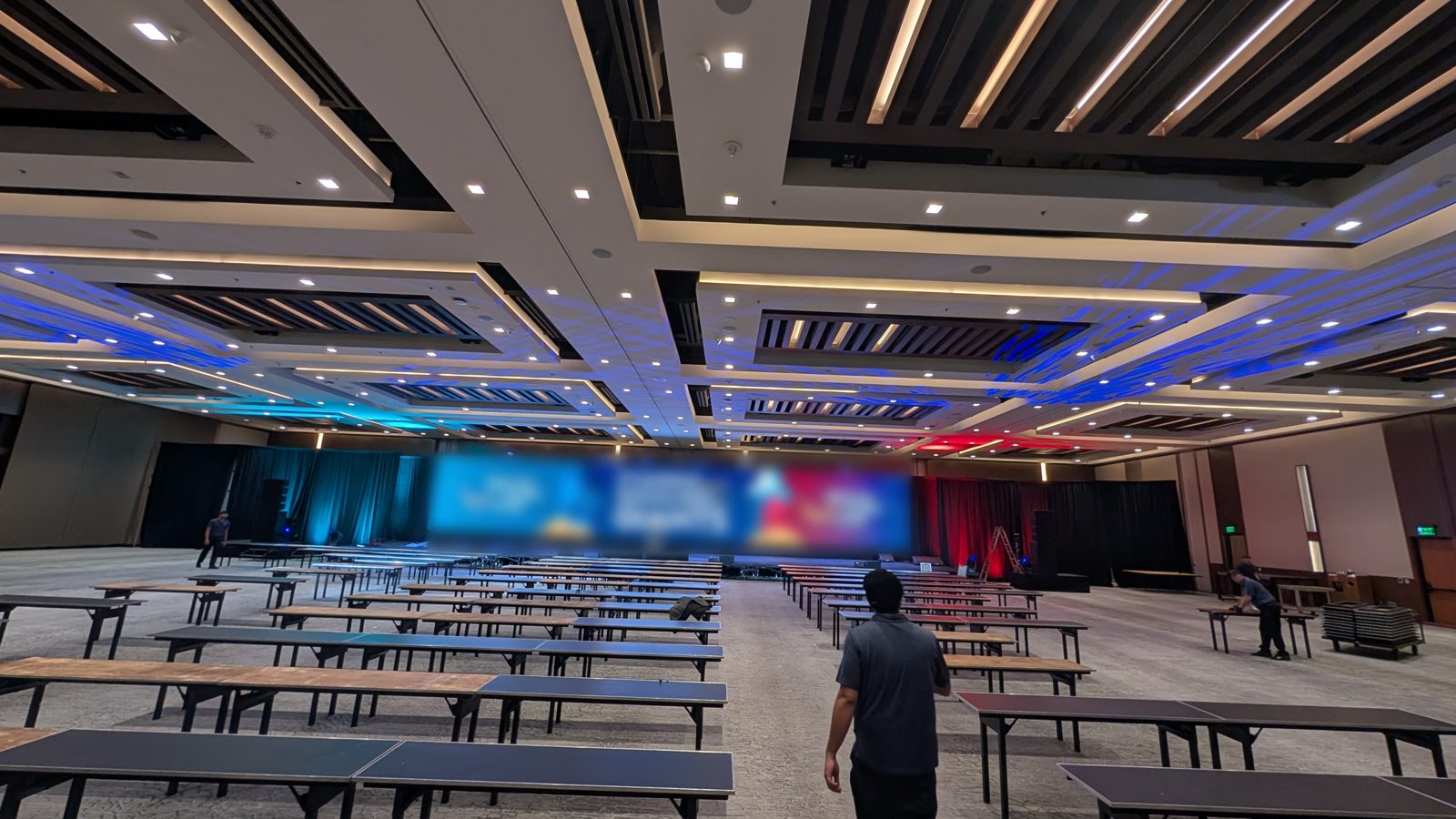 Convention ballroom set for a general session with a wide LED wall